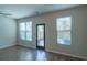 Bright living room featuring wood floors, large windows, and a glass door to the outside at 3293 Pennington Dr, Stonecrest, GA 30038