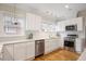 Bright kitchen featuring white cabinets, stainless steel appliances, and hardwood flooring at 101 Terrace Dr, Atlanta, GA 30305