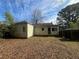 Back exterior shows a yard covered in leaves with an access door at 1907 Langston Sw Ave, Atlanta, GA 30310