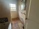 Bathroom featuring vintage tiling, with exposed plumbing, mirror, and a window for natural light at 1907 Langston Sw Ave, Atlanta, GA 30310