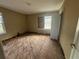 Bedroom with hardwood floors, one window boarded; ready for customization at 1907 Langston Sw Ave, Atlanta, GA 30310