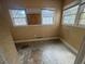 Small bedroom with boarded window, walls primed, and ready for renovation at 1907 Langston Sw Ave, Atlanta, GA 30310