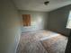 Bare bedroom with exposed floors, a boarded up window and natural light at 1907 Langston Sw Ave, Atlanta, GA 30310