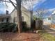 Exterior side view of the home is partially obscured by a tree and bush at 1907 Langston Sw Ave, Atlanta, GA 30310
