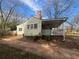 Rear exterior view features a covered porch with a single-story home at 1907 Langston Sw Ave, Atlanta, GA 30310