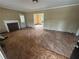 Living room featuring hardwood floors, mantel, and doorway that leads to another room at 1907 Langston Sw Ave, Atlanta, GA 30310