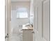 Bright bathroom featuring granite vanity, tiled floors, and white fixtures at 2592 Miriam Ln, Decatur, GA 30032