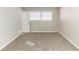 Neutral bedroom showcasing plush carpeting and a window allowing for natural light at 2592 Miriam Ln, Decatur, GA 30032