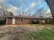 Exterior view of the rear of the brick home, with a spacious yard at 2955 Preston Dr, Rex, GA 30273