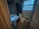 Bathroom with pedestal sink, toilet, dark shelf, and window at 2955 Preston Dr, Rex, GA 30273