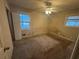 Bedroom featuring carpeted floors, a ceiling fan, and two windows at 2955 Preston Dr, Rex, GA 30273