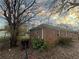 Side view of a brick home showing the landscape, including lawn and trees at 2955 Preston Dr, Rex, GA 30273