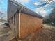 Angled view of the side of a brick house, showcasing its durable construction at 2955 Preston Dr, Rex, GA 30273