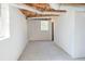 Unfinished basement showing concrete floor, exposed ceiling and window at 4011 Lake Carlton Rd, Loganville, GA 30052