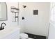 Updated bathroom featuring a black shower fixture, white tiled walls, and a modern vanity at 4011 Lake Carlton Rd, Loganville, GA 30052