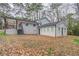 An angle of the back of the home shows the porch, siding and windows from the yard at 2304 Wesley Chapel Rd, Decatur, GA 30035