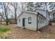 A view of the back exterior with new siding and windows and a door leading to the outside at 2304 Wesley Chapel Rd, Decatur, GA 30035