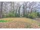 The large backyard with mature trees is ready for outdoor activities and entertaining at 2304 Wesley Chapel Rd, Decatur, GA 30035