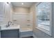 Clean bathroom featuring a tub/shower combo, a single vanity, and a window at 2304 Wesley Chapel Rd, Decatur, GA 30035