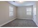 A carpeted bedroom with windows allowing natural light at 2304 Wesley Chapel Rd, Decatur, GA 30035