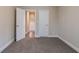An empty room with carpet and white trim and white doors at 2304 Wesley Chapel Rd, Decatur, GA 30035