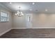 Dining room featuring gray wood floors, a chandelier, recessed lights, and an exterior door at 2304 Wesley Chapel Rd, Decatur, GA 30035