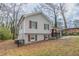 Charming home featuring a carport, red front door, grey siding, and painted brick foundation at 2304 Wesley Chapel Rd, Decatur, GA 30035