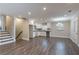 Open kitchen featuring white cabinetry, dark countertops, and gray wood floors at 2304 Wesley Chapel Rd, Decatur, GA 30035