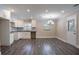Open kitchen featuring white cabinetry, dark countertops, and gray wood floors at 2304 Wesley Chapel Rd, Decatur, GA 30035