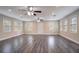 Spacious living room with modern gray wood floors, recessed lighting, and multiple windows at 2304 Wesley Chapel Rd, Decatur, GA 30035