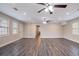 Spacious living room with modern gray wood floors, recessed lighting, and multiple windows at 2304 Wesley Chapel Rd, Decatur, GA 30035