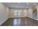 Living room features wood floors, recessed lights, a staircase, and a white exterior door at 2304 Wesley Chapel Rd, Decatur, GA 30035