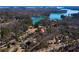 Aerial view of the home's location near the lake and lush wooded areas at 3550 Beaver Cove Rd, Cumming, GA 30041