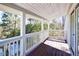 Bright and airy balcony with white railings and wood deck overlooking the trees at 3550 Beaver Cove Rd, Cumming, GA 30041