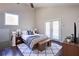 Bright and airy bedroom with a view, featuring a cozy rug and stylish décor at 3550 Beaver Cove Rd, Cumming, GA 30041