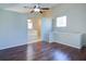 Spacious bedroom featuring hardwood floors and an ensuite bathroom with a tub at 3550 Beaver Cove Rd, Cumming, GA 30041