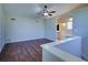 Bright bedroom featuring hardwood floors, a ceiling fan, and an ensuite bathroom at 3550 Beaver Cove Rd, Cumming, GA 30041