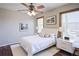 Bright bedroom with crisp white bedding, minimalist décor, and large windows at 3550 Beaver Cove Rd, Cumming, GA 30041