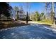 Charming home with two-story decks and a long driveway, nestled among mature trees at 3550 Beaver Cove Rd, Cumming, GA 30041