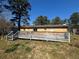A backyard with a worn deck area, showing the house's back exterior with windows and door at 3623 Stanford Cir, Decatur, GA 30034