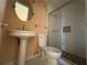 Bathroom featuring pedestal sink, toilet, and shower with glass door and tiled accents at 3623 Stanford Cir, Decatur, GA 30034