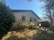 Back exterior of house showcasing brick siding, mature trees, and a partially fenced yard at 3623 Stanford Cir, Decatur, GA 30034