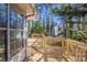 A spacious wooden back deck offers serene views of surrounding trees at 6381 Phillips Creek Dr, Lithonia, GA 30058