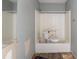 A bathroom with a tub and shower combo is ready for complete renovation and modernization at 6381 Phillips Creek Dr, Lithonia, GA 30058