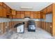 Dated kitchen showing exposed wall studs, wooden cabinets, and a black gas range at 6381 Phillips Creek Dr, Lithonia, GA 30058
