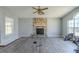 Spacious living room with a stone fireplace, modern flooring, and large windows for natural light at 6381 Phillips Creek Dr, Lithonia, GA 30058