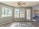 Bright living room with stone fireplace, ceiling fan, and lots of natural light from large windows at 6381 Phillips Creek Dr, Lithonia, GA 30058