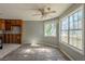 Open-concept living room with gray flooring leading to a kitchen with outdated wooden cabinetry at 6381 Phillips Creek Dr, Lithonia, GA 30058