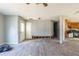 Open-concept living room with gray flooring leading to a kitchen needing renovation at 6381 Phillips Creek Dr, Lithonia, GA 30058