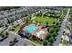 Aerial view of a community pool, playground, and surrounding homes in a well-planned neighborhood at 951 Olmsted Ln, Johns Creek, GA 30097